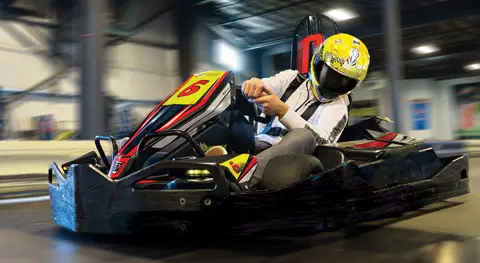 A business man races a gokart