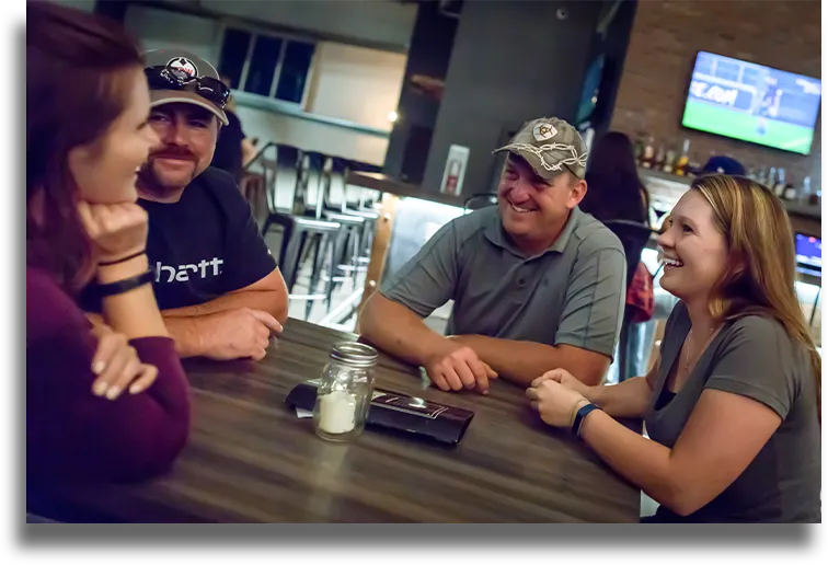 A group of friends sit around a table at Overdrive Sports Bar