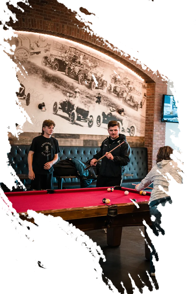 A torn edge photo of people playing pool