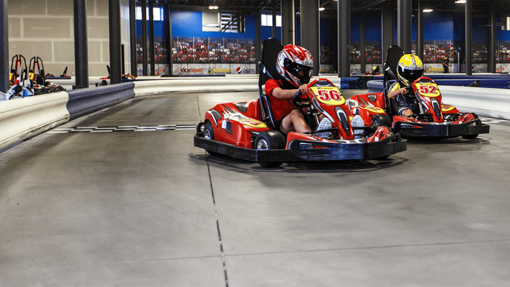 photo of kids racing karts on a track