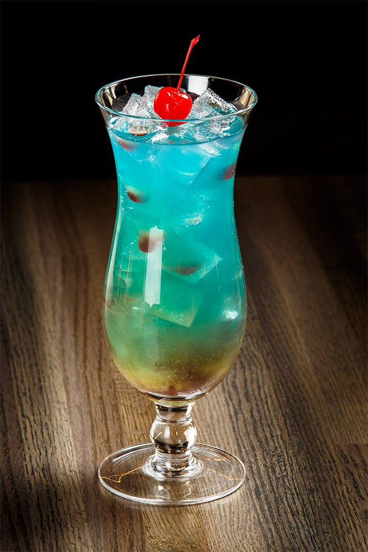 photo of a blue mixed cocktail in a tall glass
