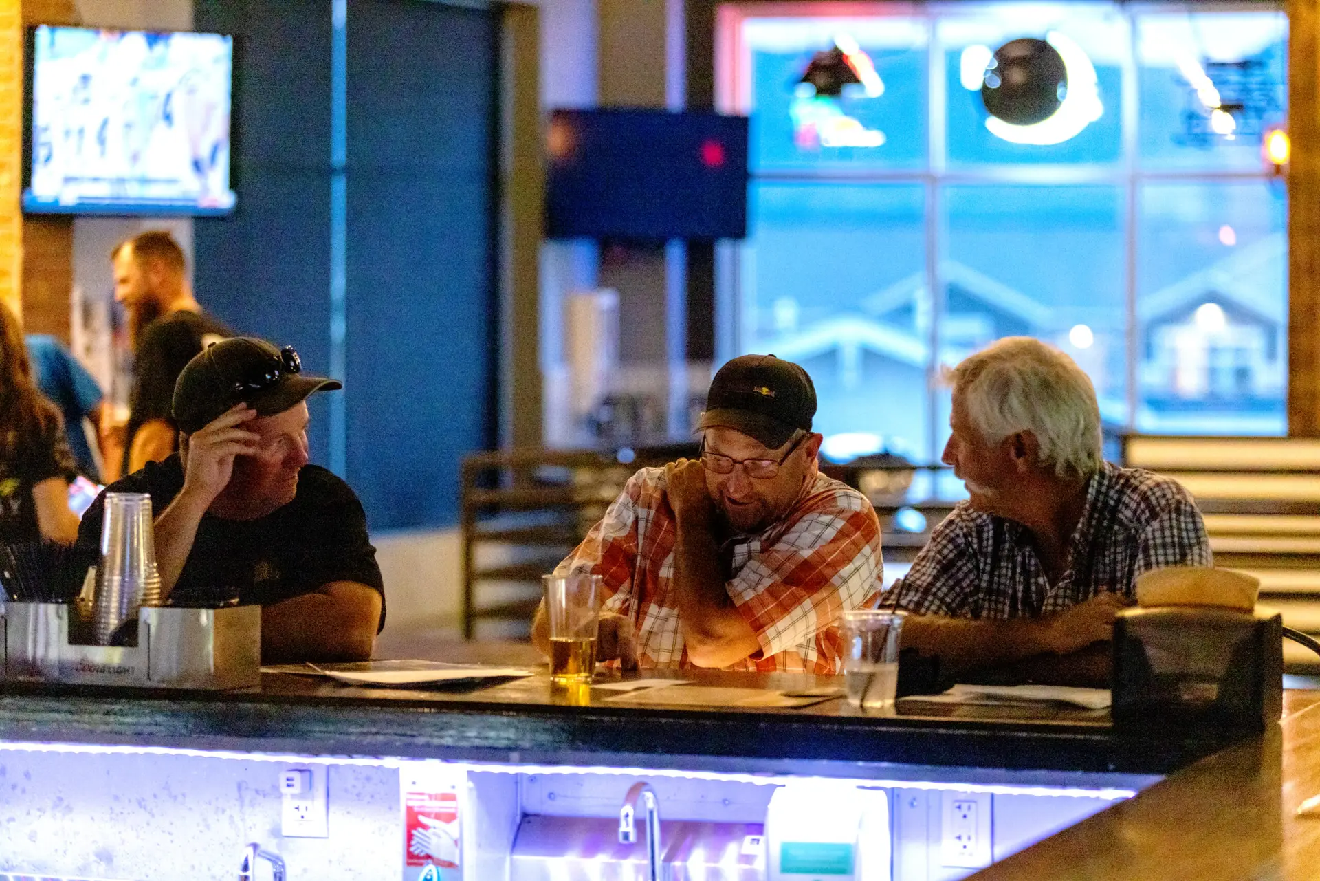 A group of friends sit at a sports bar in Colorado Springs